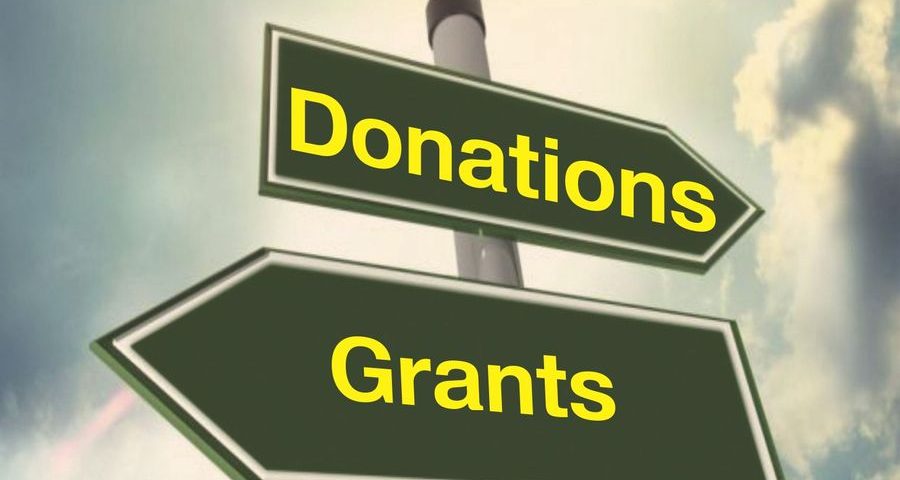 Signposts pointing to donations in one direction, and grants in the other