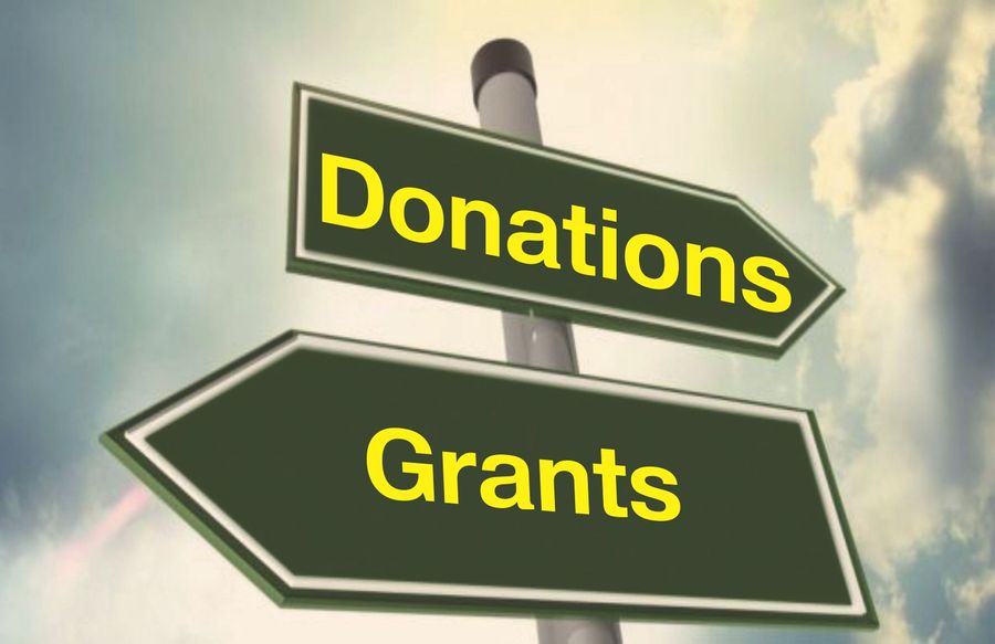 Signposts pointing to donations in one direction, and grants in the other