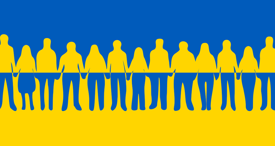 Silhouettes of people holding hands on Ukraine flag