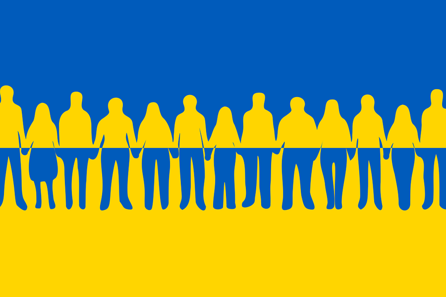 Silhouettes of people holding hands on Ukraine flag