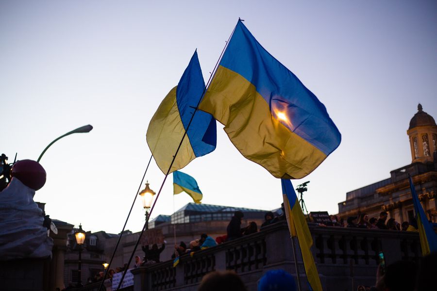 Ukrainian flags fly at a protest against the war