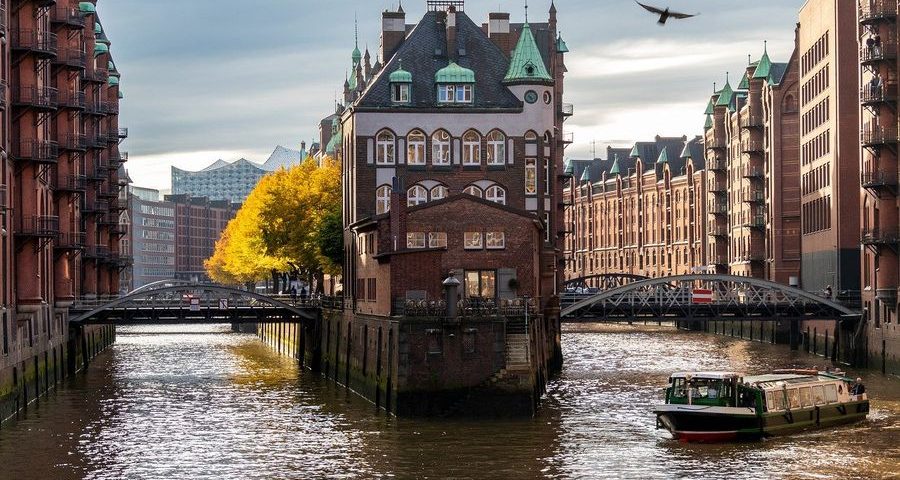 A scene in Hamburg, Germany of buildings surrounded by water. Image by Karsten Bergmann from Pixabay