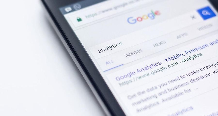 A phone displays Google Analytics in a Google search. By Pexels on Pixabay