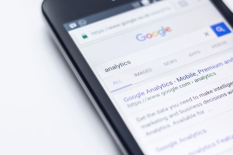 A phone displays Google Analytics in a Google search. By Pexels on Pixabay