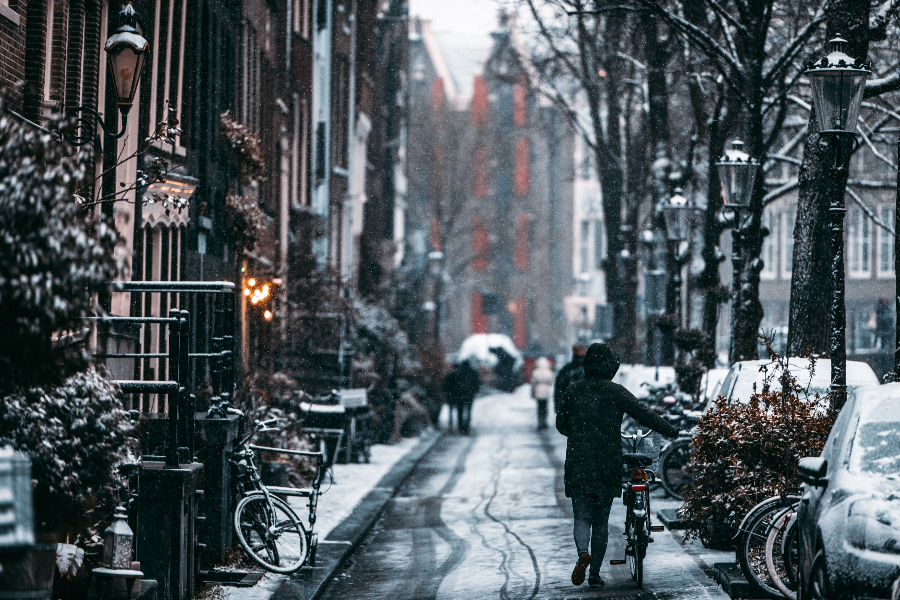 A bicycle on a snowy Dutch street. By Redcharlie on Unsplash.