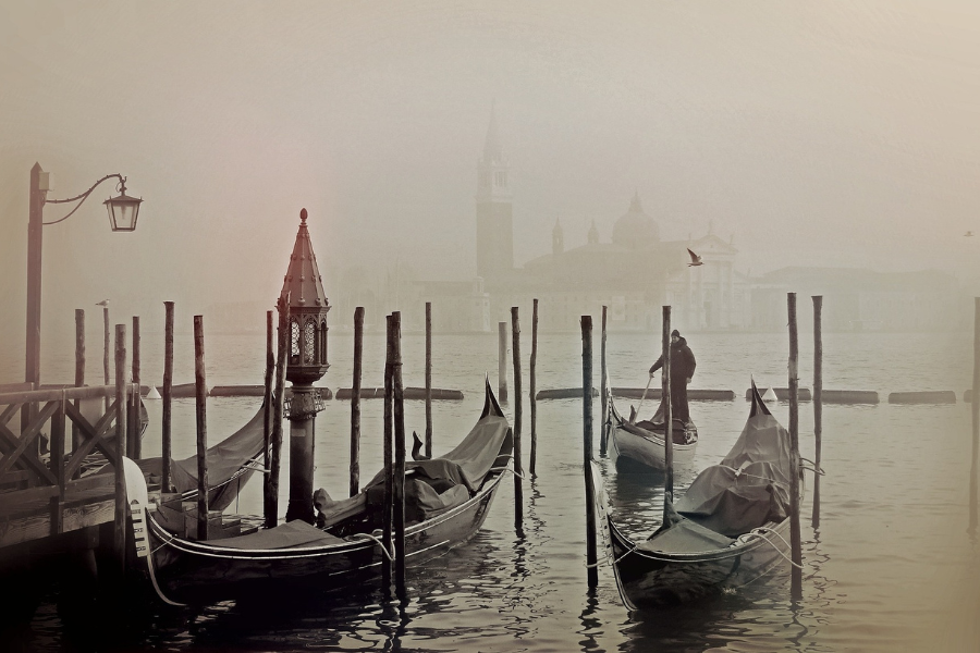 A misty scene with gondolas in Venice
