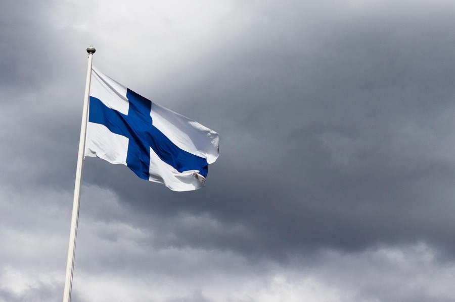 The Finnish flag against a grey sky