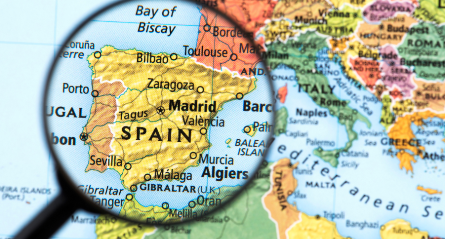 Spain on a map, under a magnifying glass. From Canva