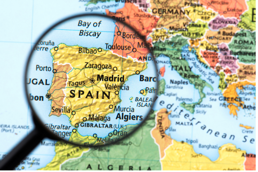 Spain on a map, under a magnifying glass. From Canva