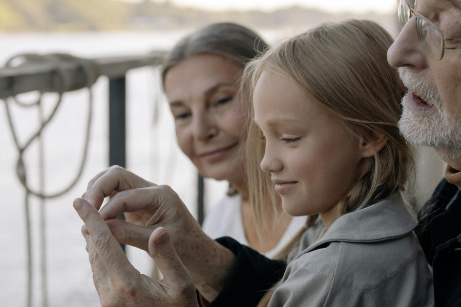 A young girl with her grandparents. By cottonbro studio via Pexels