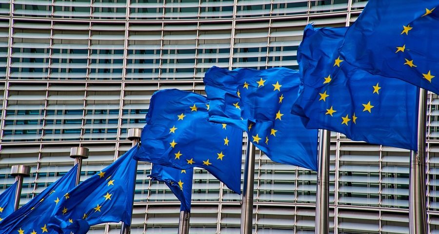 EU flags flying outside a building in Brussels. By NakNakNak on Pixabay