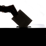 A hand putting a voting paper in a ballot box. Photo by Element5 Digital on Pexels