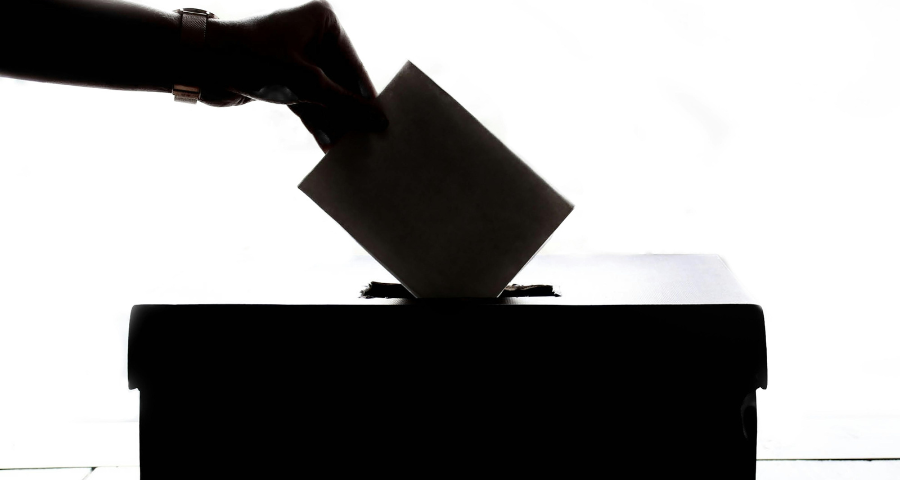 A hand putting a voting paper in a ballot box. Photo by Element5 Digital on Pexels