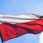 A Polish flag rippling in the wind. By freestocks-photos on Pixabay