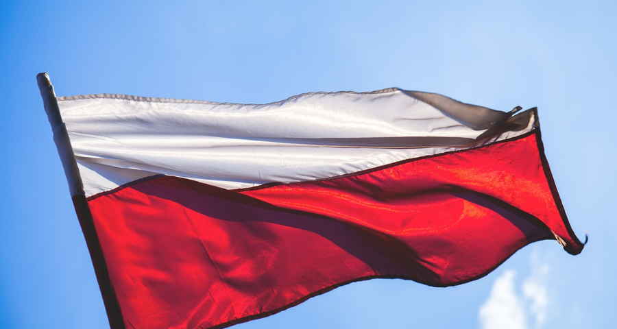 A Polish flag rippling in the wind. By freestocks-photos on Pixabay