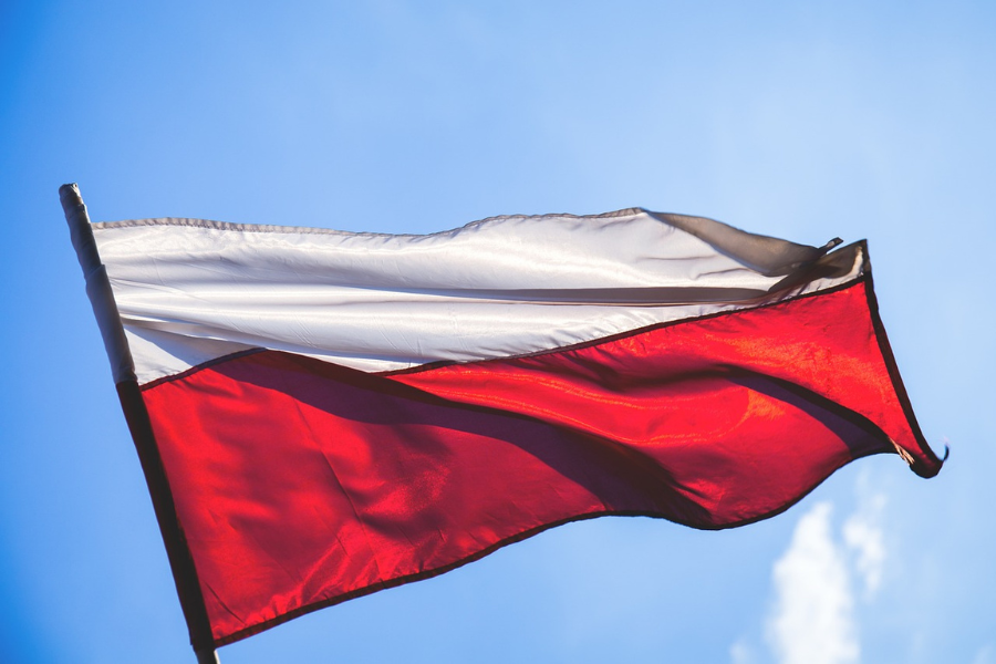 A Polish flag rippling in the wind. By freestocks-photos on Pixabay