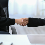 Two business women shaking hands. By Getty Images for Unsplash+