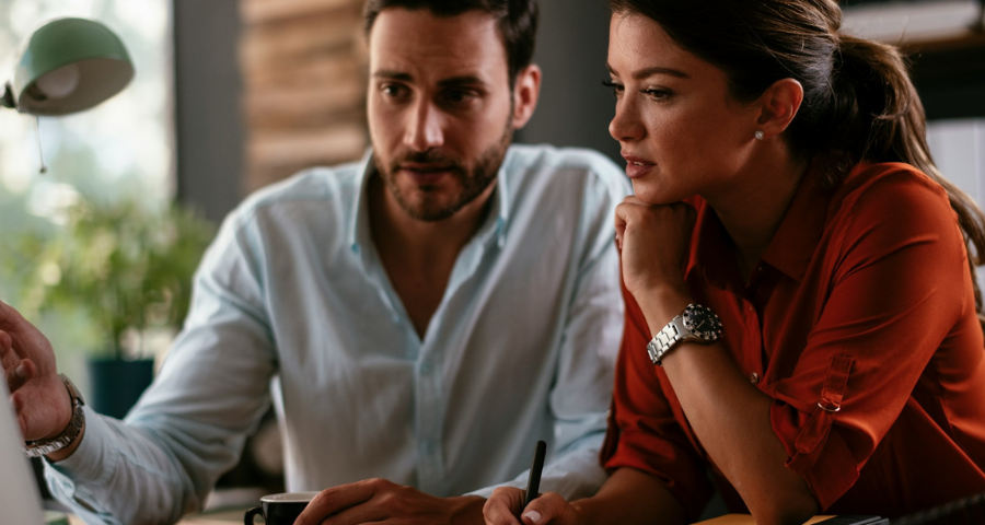 two coworkers in discussion. Getty Images for Unsplash+