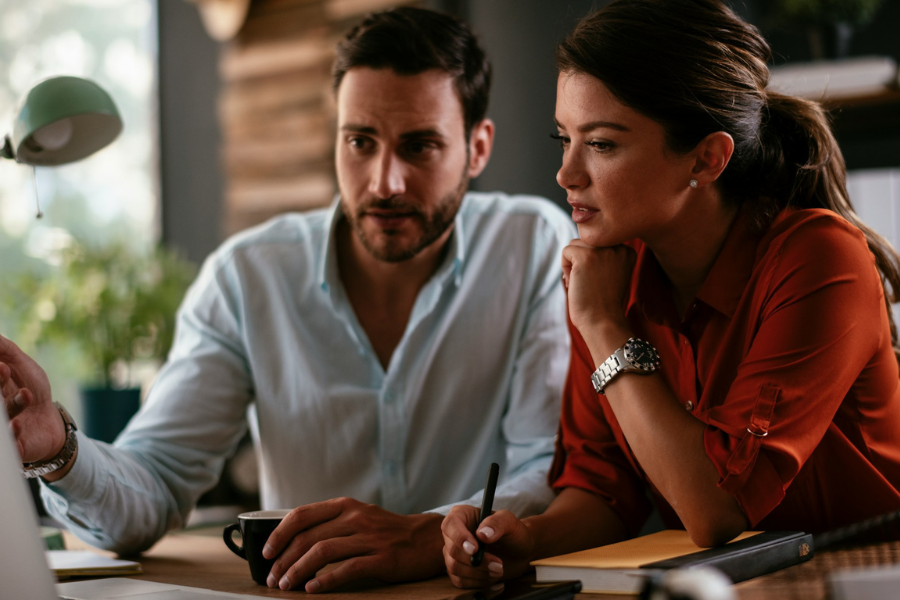 two coworkers in discussion. Getty Images for Unsplash+