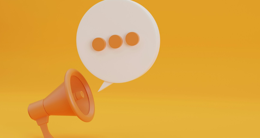 Illustration of an orange megaphone with a speech bubble containing q row of 3 dots. By Getty Images for Unsplash+