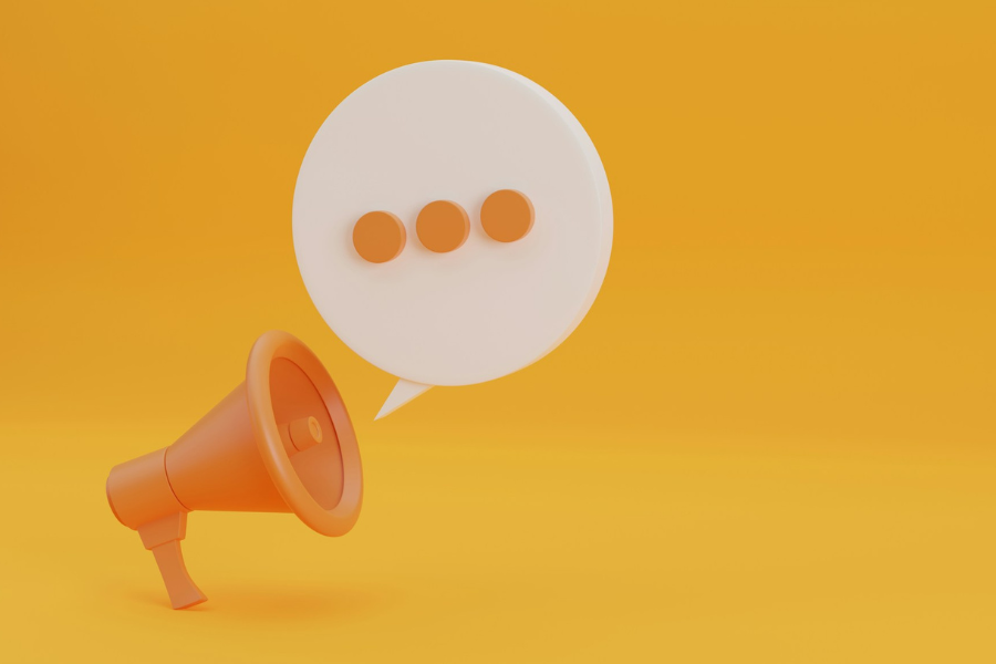 Illustration of an orange megaphone with a speech bubble containing q row of 3 dots. By Getty Images for Unsplash+