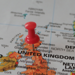 A red pin marks Scotland on a map. By Beate Vogl via Pexels