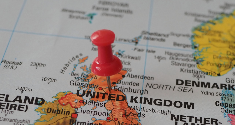A red pin marks Scotland on a map. By Beate Vogl via Pexels