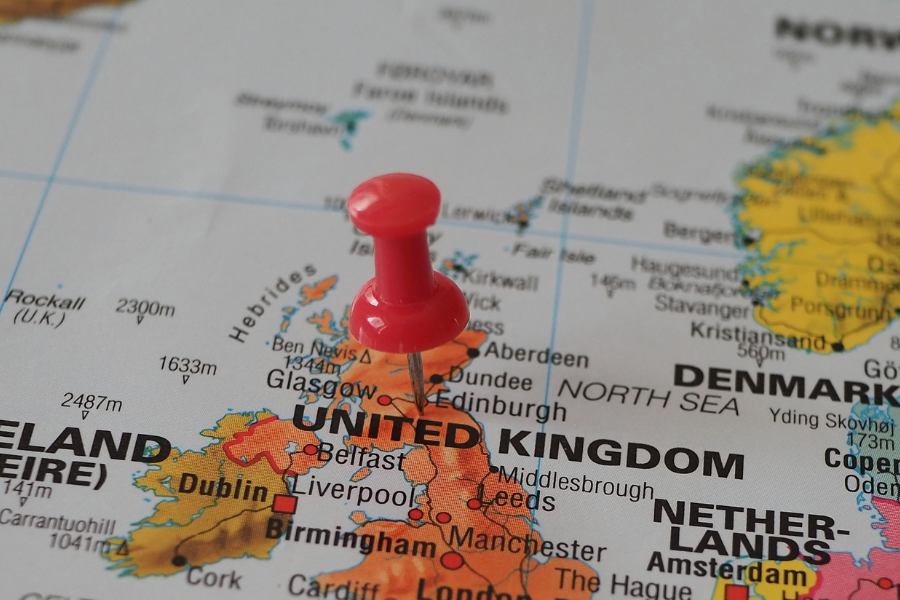 A red pin marks Scotland on a map. By Beate Vogl via Pexels