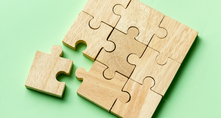 A wooden puzzle with a displaced piece by Curated Lifestyle on Unsplash+