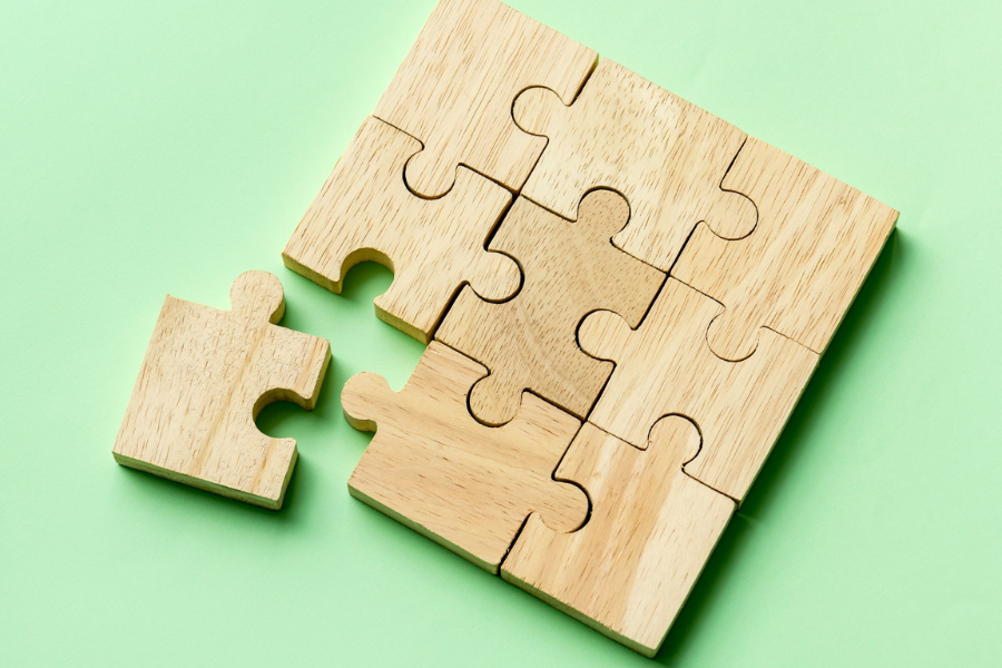 A wooden puzzle with a displaced piece by Curated Lifestyle on Unsplash+