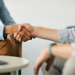 Two men shaking hands by Getty Images for Unsplash+