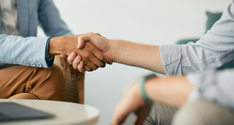 Two men shaking hands by Getty Images for Unsplash+