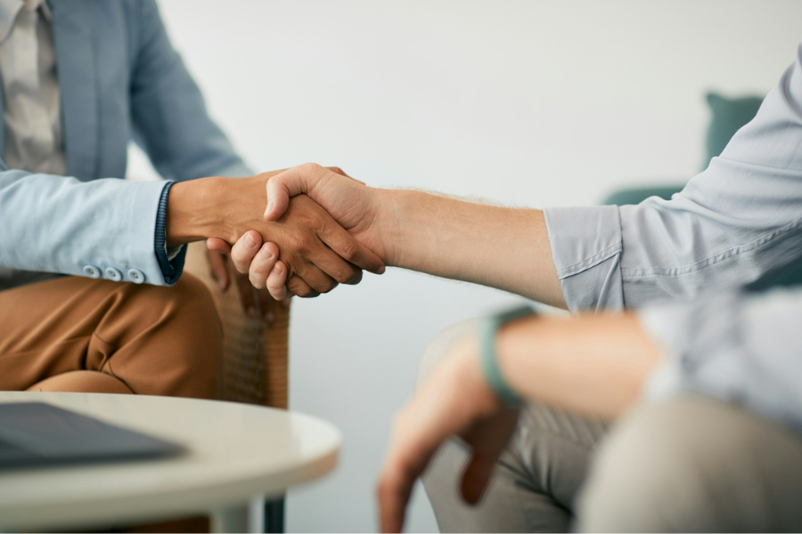 Two men shaking hands by Getty Images for Unsplash+