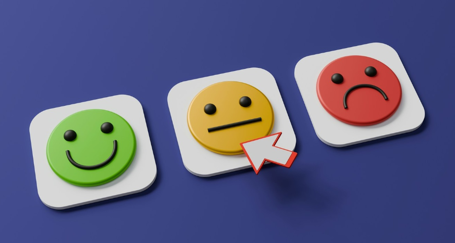 A row of three emoji faces depicting happy, so so and sad. By A Chosen Soul on Unsplash