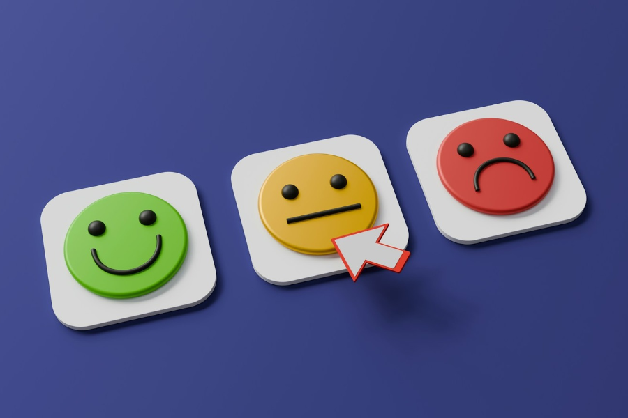 A row of three emoji faces depicting happy, so so and sad. By A Chosen Soul on Unsplash
